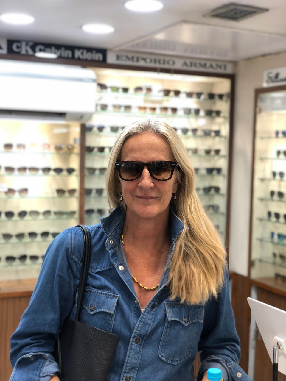 Customer styling sunglasses at Khanna Vision